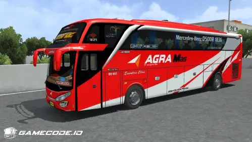 Tampilan samping bus merah dengan aksen putih dan ikon WiFi di kaca