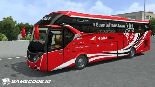 Bus merah-putih dengan motif singa di belakang dan tulisan ScaniaTransJawa di kaca
